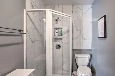 a bathroom with a shower with a toilet at Peaceful Cottage about 8 Mi to Downtown Toledo! in Toledo