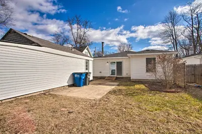 a white house with a garage at Peaceful Cottage about 8 Mi to Downtown Toledo! in Toledo