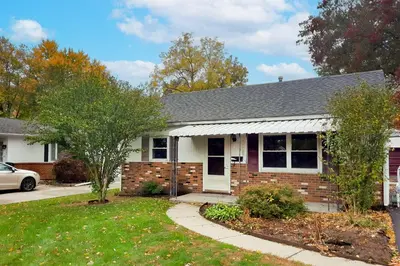 a brick house with a car parked in front of it at Peaceful Cottage about 8 Mi to Downtown Toledo! in Toledo