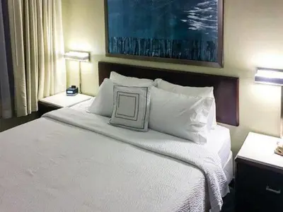 a bedroom with a large bed with white pillows at King's Inn Mason,Ohio in Cincinnati