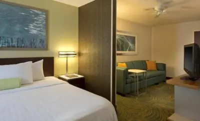 a hotel room with a bed and a couch at King's Inn Mason,Ohio in Cincinnati