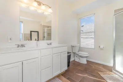 a white bathroom with a sink and a toilet at Downtown Views-Prime Location! in Cincinnati