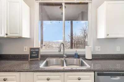 a kitchen counter with a sink and a window at Downtown Views-Prime Location! in Cincinnati