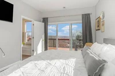 a bedroom with a bed and a large window at Downtown Views-Prime Location! in Cincinnati