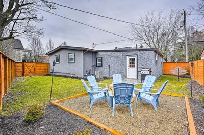 a backyard with a table and chairs and a house at German Village Getaway with Grill 4 Mi to OSU! in Columbus