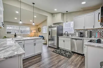 a kitchen with white cabinets and stainless steel appliances at German Village Getaway with Grill 4 Mi to OSU! in Columbus