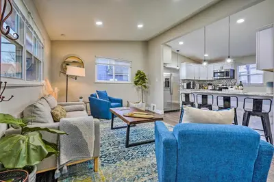 a living room with blue chairs and a kitchen at German Village Getaway with Grill 4 Mi to OSU! in Columbus