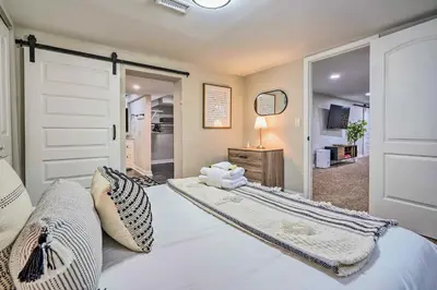 a bedroom with a bed and a sliding door at German Village Getaway with Grill 4 Mi to OSU! in Columbus