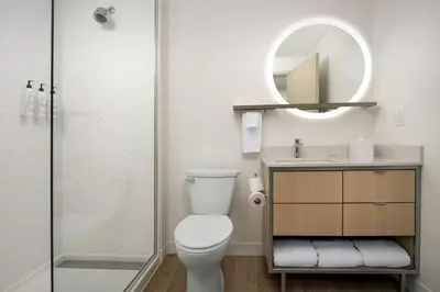 a bathroom with a toilet and a sink and a mirror at TownePlace Suites by Marriott Cincinnati Mason in Mason