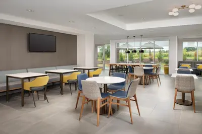 a dining room with tables and chairs at TownePlace Suites by Marriott Cincinnati Mason in Mason