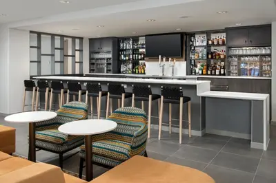 a bar in a restaurant with chairs and tables at TownePlace Suites by Marriott Cincinnati Mason in Mason