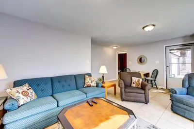 a living room with a blue couch and a table at Pet-Friendly Youngstown Cottage with Yard in Youngstown
