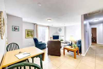 a living room and dining room with a table and chairs at Pet-Friendly Youngstown Cottage with Yard in Youngstown