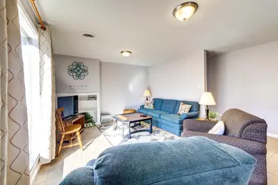 a living room with a blue couch and a table at Pet-Friendly Youngstown Cottage with Yard in Youngstown