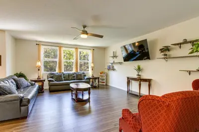 a living room with couches and chairs and a ceiling fan at Private Backyard! Spacious Home 25 Mi to Columbus in New Albany