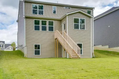a house with a staircase on the side of it at Private Backyard! Spacious Home 25 Mi to Columbus in New Albany