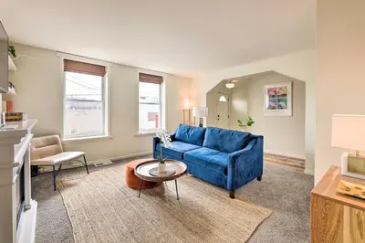 a living room with a blue couch and a table at Cincinnati Vacation Rental 6 Mi to Downtown! in Cincinnati