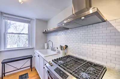 a kitchen with a stove top oven next to a sink at Cincinnati Vacation Rental 6 Mi to Downtown! in Cincinnati