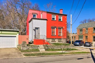 a red and white house on a street at Cincinnati Vacation Rental 6 Mi to Downtown! in Cincinnati
