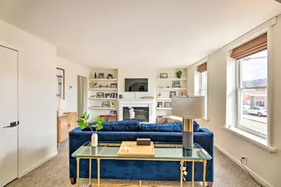 a living room with a blue couch and a table at Cincinnati Vacation Rental 6 Mi to Downtown! in Cincinnati
