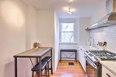 a kitchen with a wooden table and a counter top at Cincinnati Vacation Rental 6 Mi to Downtown! in Cincinnati