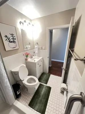 a bathroom with a white toilet and a sink at Sunny Stay Bright and Cozy Suite 1 in Cincinnati