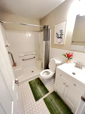 a bathroom with a white toilet and a sink at Sunny Stay Bright and Cozy Suite 1 in Cincinnati