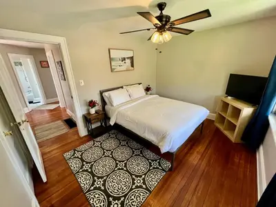 a bedroom with a bed and a ceiling fan at Cozy Bungalow Quiet Neighborhood Suite 1 in Cincinnati