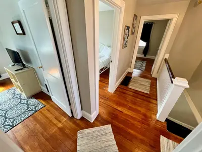 a hallway with a stairway leading to a bedroom at Cozy Bungalow Quiet Neighborhood Suite 1 in Cincinnati