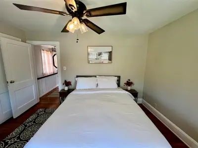 a bedroom with a bed with a ceiling fan at Cozy Bungalow Quiet Neighborhood Suite 1 in Cincinnati