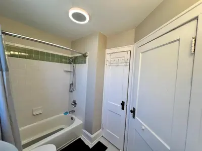 a bathroom with a tub and a shower and a toilet at Cozy Bungalow Quiet Neighborhood Suite 1 in Cincinnati