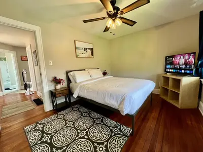 a bedroom with a bed and a ceiling fan at Cozy Bungalow Quiet Neighborhood Suite 1 in Cincinnati