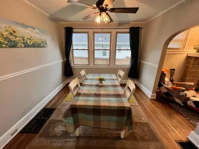 a dining room with a table and a couch at Cozy Bungalow Quiet Neighborhood Suite 1 in Cincinnati