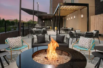 a fire pit on a patio with tables and chairs at SpringHill Suites by Marriott Cincinnati Mason in Mason