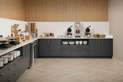a kitchen with black cabinets and white counter tops at SpringHill Suites by Marriott Cincinnati Mason in Mason