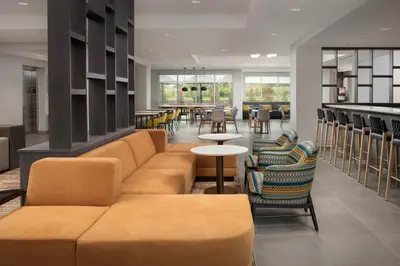 a lobby with a couch and tables and chairs at SpringHill Suites by Marriott Cincinnati Mason in Mason