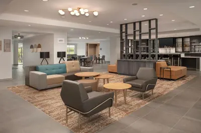 a lobby with couches and chairs and tables at SpringHill Suites by Marriott Cincinnati Mason in Mason