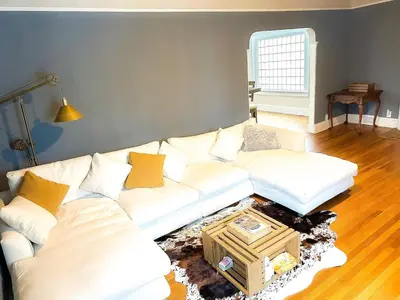 a living room with a white couch and a table at IvyLand Pines in Cleveland Heights