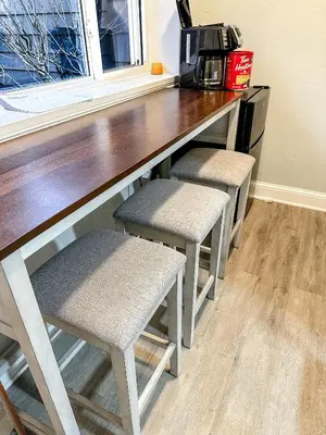 a kitchen with a counter with two stools under a counter top at IvyLand Pines in Cleveland Heights