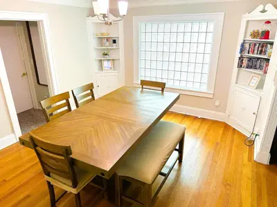 a dining room with a wooden table and chairs at IvyLand Pines in Cleveland Heights