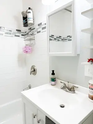 a white bathroom with a sink and a mirror at IvyLand Pines in Cleveland Heights