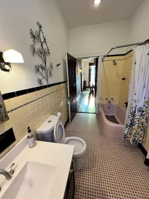a bathroom with a toilet and a sink and a tub at Skyline Retreat Spacious Elegance Queen Suite 2 City Views in Cincinnati