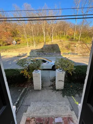 a white car parked in front of a house at Skyline Retreat Spacious Elegance Queen Suite 2 City Views in Cincinnati