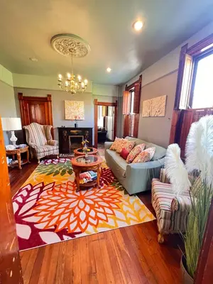 a living room with a couch and a table at Skyline Retreat Spacious Elegance Queen Suite 2 City Views in Cincinnati