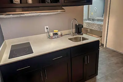 a kitchen with a sink and a counter top at Suburban Studios Montpelier in Montpelier