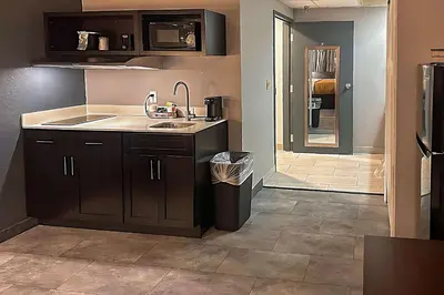 a kitchen with a sink and a counter top at Suburban Studios Montpelier in Montpelier