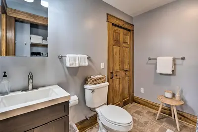 a bathroom with a white toilet and a sink at Gambier Vacation Rental about 5 Mi to Mt Vernon! in Gambier