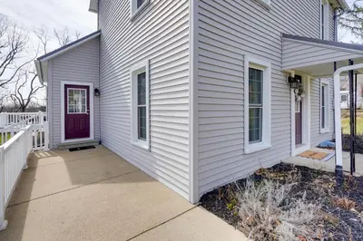 a white house with a purple door at Gambier Vacation Rental about 5 Mi to Mt Vernon! in Gambier