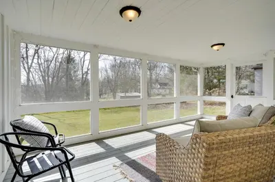 a screened in porch with a couch and chairs at Gambier Vacation Rental about 5 Mi to Mt Vernon! in Gambier