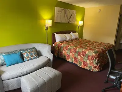 a hotel room with a bed and a couch at Lebanon Inn Motel in Lebanon